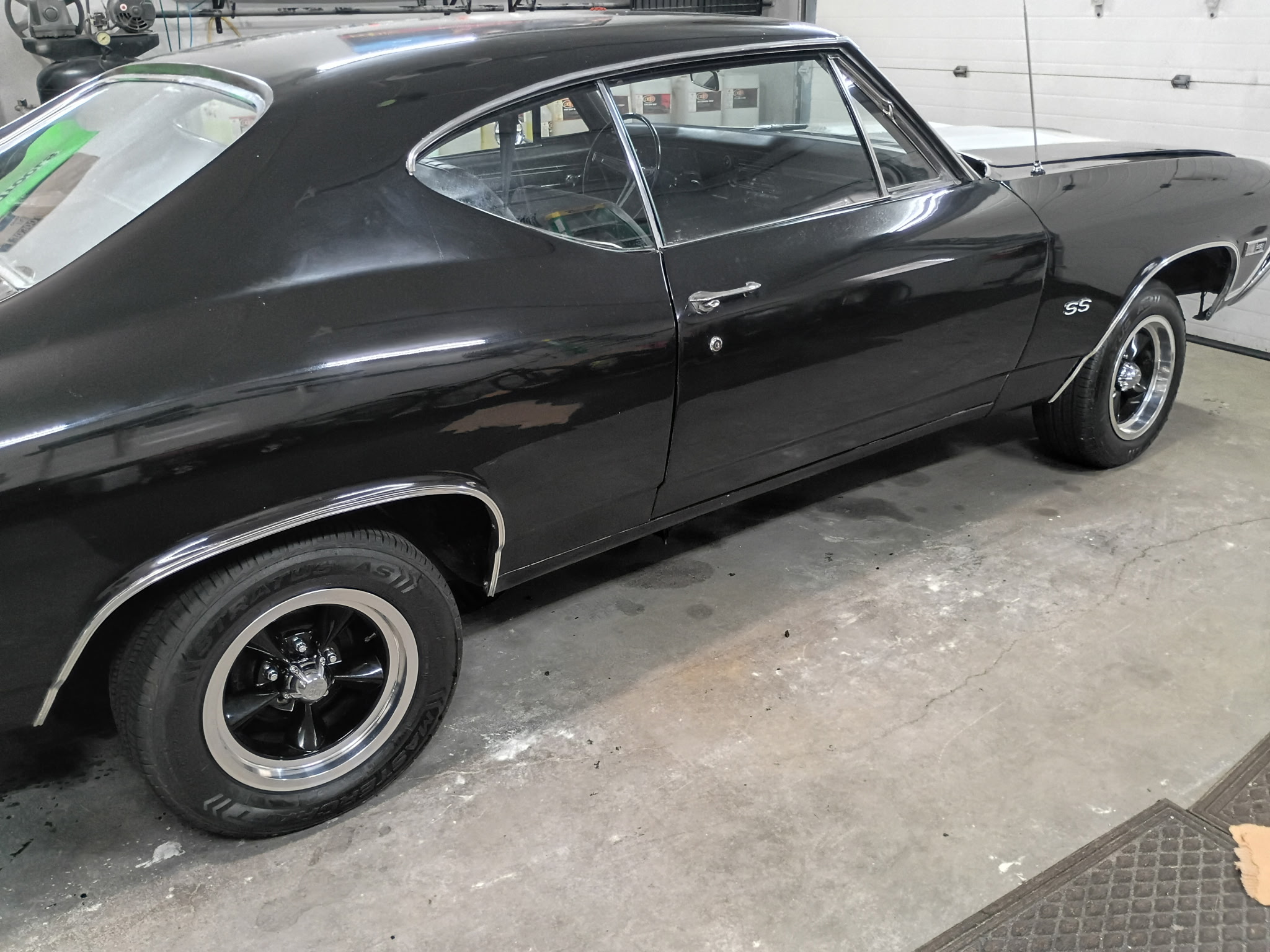 Black 1968 Chevrolet Chevelle profile showing chrome trim and classic five-spoke wheels