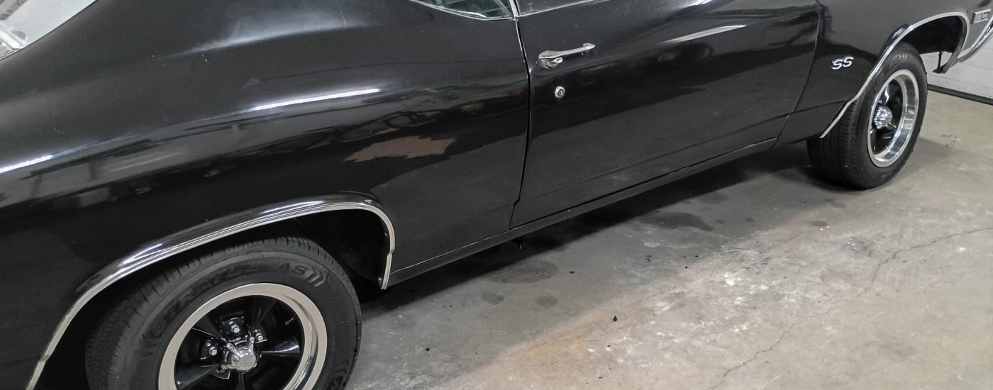 Black 1968 Chevrolet Chevelle profile showing chrome trim and classic five-spoke wheels