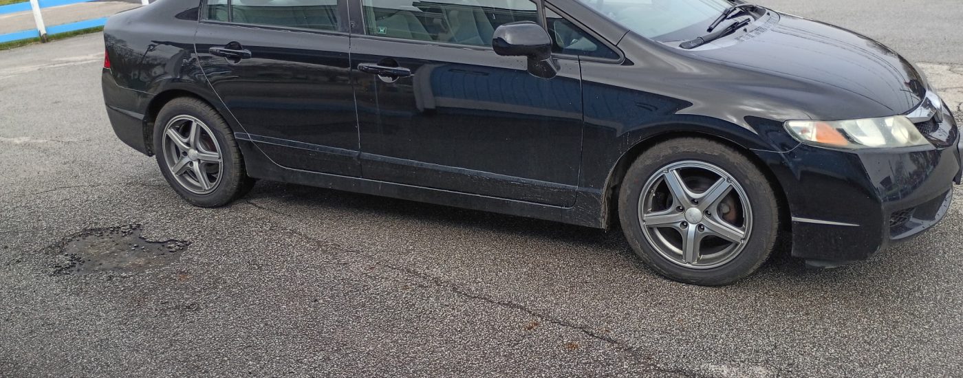 Black 2010 Honda Civic four-door sedan profile