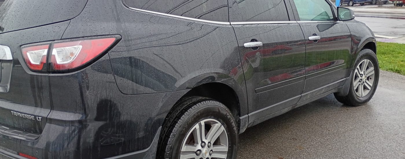 Black 2015 Chevy Traverse LT rear profile view